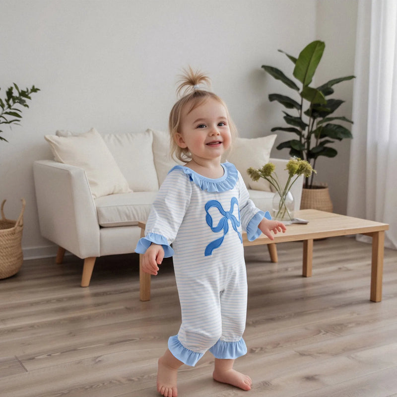 Toddler wearing the Little Bow Peep adorable long sleeve baby romper, smiling in a cozy indoor environment, exuding charm and warmth.
