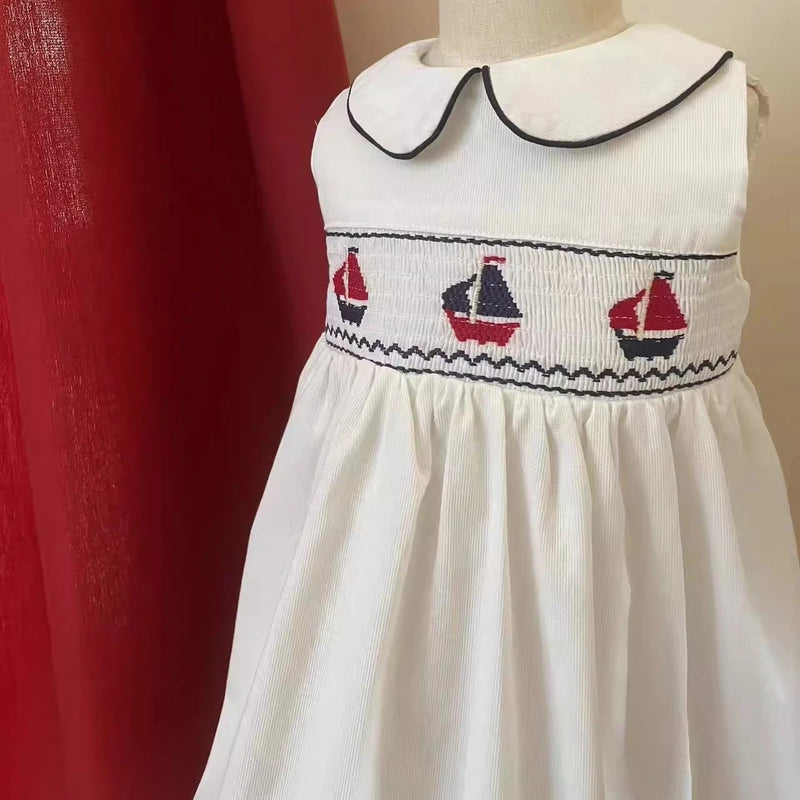 Set Sail Little Girl's Party Dress featuring hand-embroidered sailboats and Peter Pan collar, perfect for summer parties.