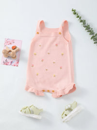 Pink floral knit romper for babies, with shoulder straps, wooden buttons, embroidered flowers, and a frilled hem.