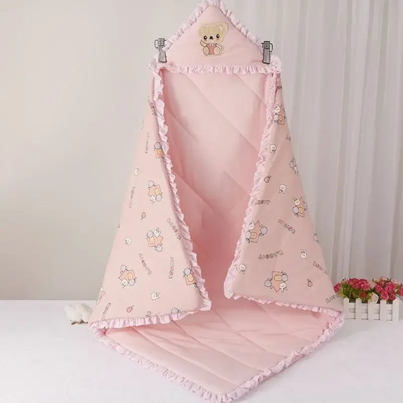 Charming pink 'Animal Cutie' baby swaddle wrap designed with playful graphics, providing warmth for chilly days.