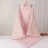 Charming pink 'Animal Cutie' baby swaddle wrap designed with playful graphics, providing warmth for chilly days.