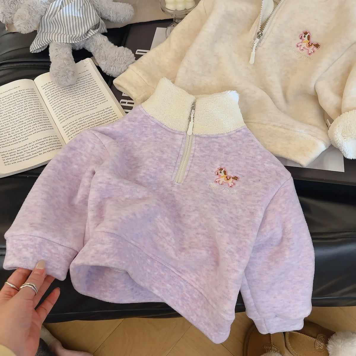 Polly purple children's fleece pullover with embroidered horse zipper detail. Soft long-sleeve fall and winter kids sweater.