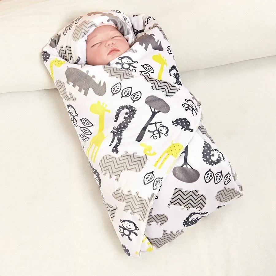 Sleeping baby wrapped in lightweight ultra-soft micro-plush reversible blanket with 4-color animal prints