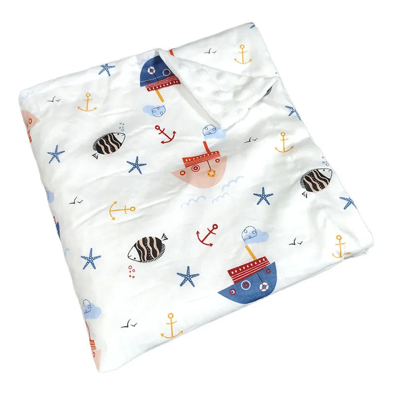 White dotted minky blanket with colorful nautical prints—ships, anchors, and starfish for babies and young children.