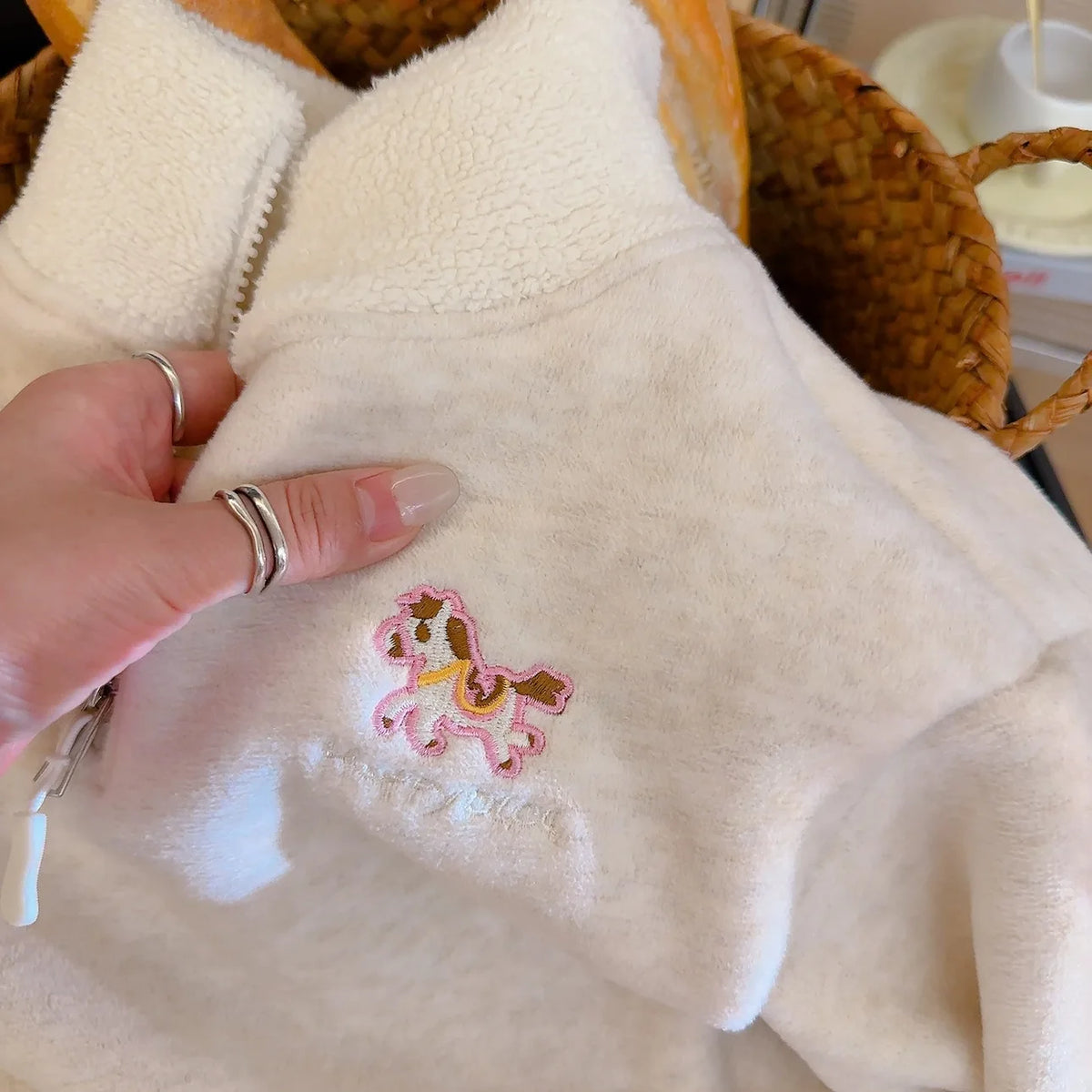 Soft white kids fleece pullover featuring a cute pink embroidered horse zipper detail for cozy autumn and winter wear.