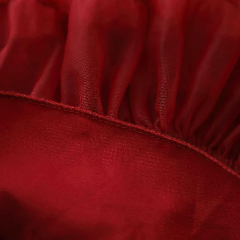 Detailed view of the tulle skirt from the Strawberry Girls Knit Sweater and Tulle Skirt - Deep Red, showcasing its flouncy, layered design perfect for twirling.