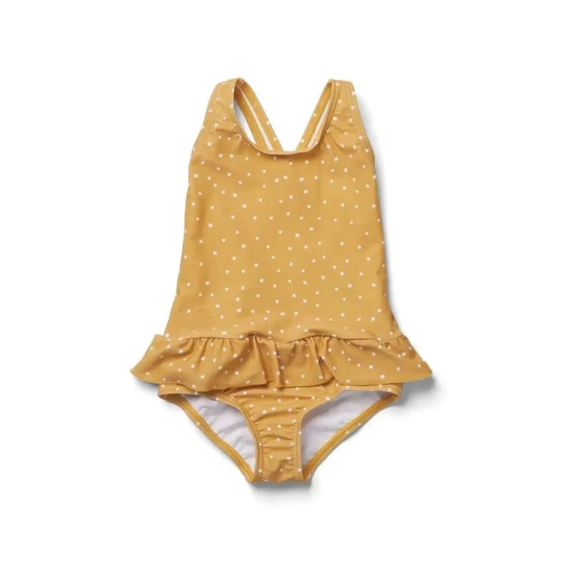 Frilly polka-dot sun-protective one-piece swimsuit for girls with crisscross back and ruffle hem.