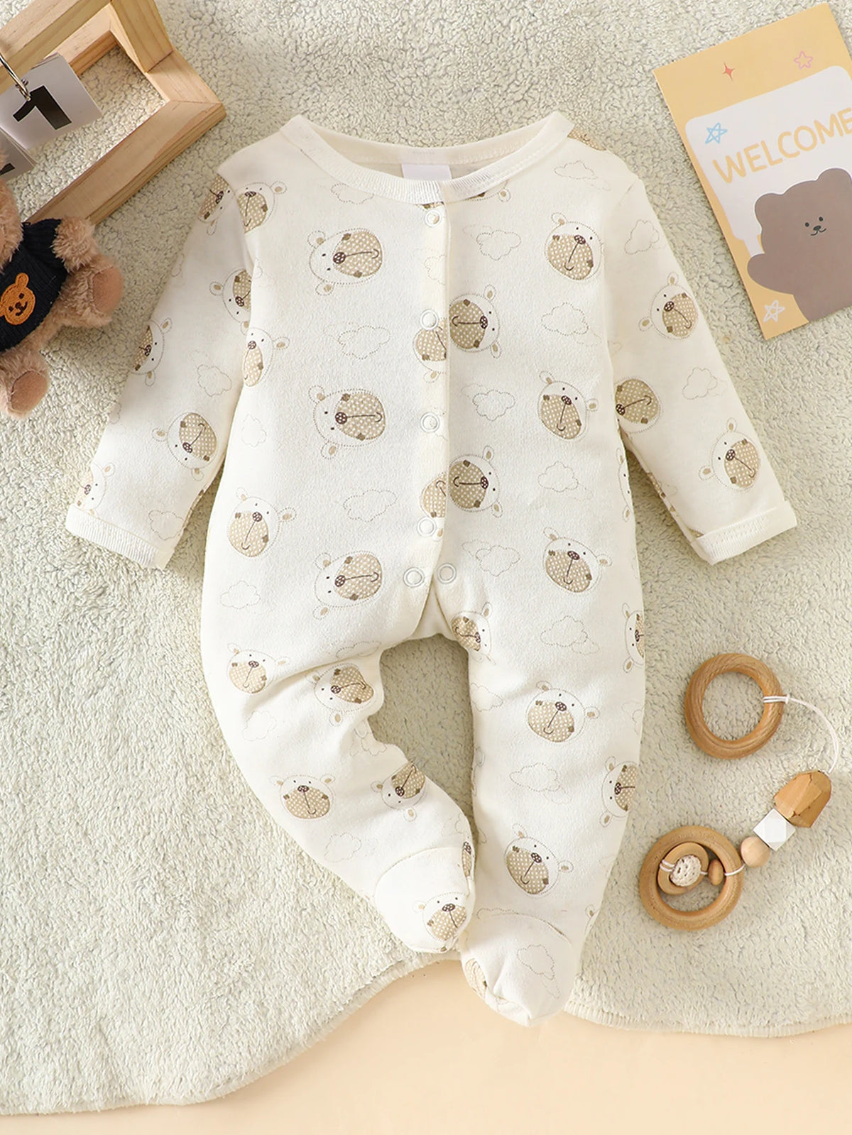 Little Bear beige 8-piece newborn romper set, 100% cotton with bear pattern and front and leg snaps.