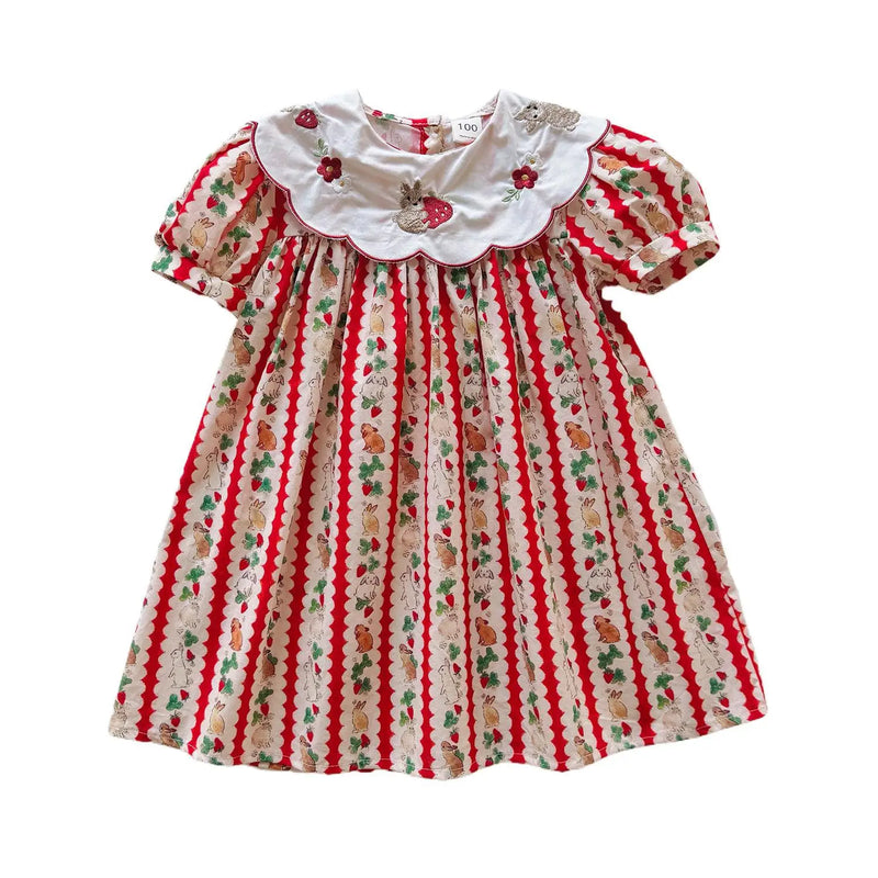 Isolated image of the 'Constance-Marie' classic embroidered dress for girls, which features a fun strawberry pattern and a charming Peter Pan collar.