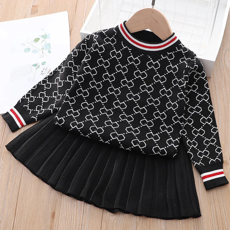 The "Morgan" Classic Knit Skirt Set in black featuring a cozy pullover sweater paired with a chic pleated skirt, perfect for girls aged 4-6.