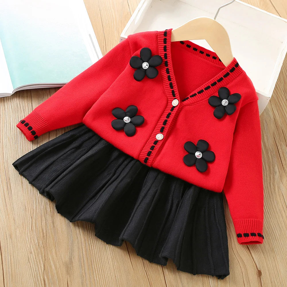 Vanessa Floral Knitted Cardigan and Pleated Skirt Set: red cardigan with black flower appliques, black pleated skirt.