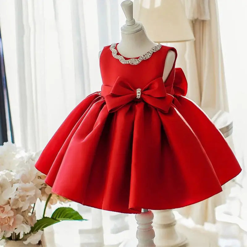 Melanie-Marie Lovely Red Sparkly Party Dress featuring a big bow, showcasing a charming and elegant design perfect for special occasions.