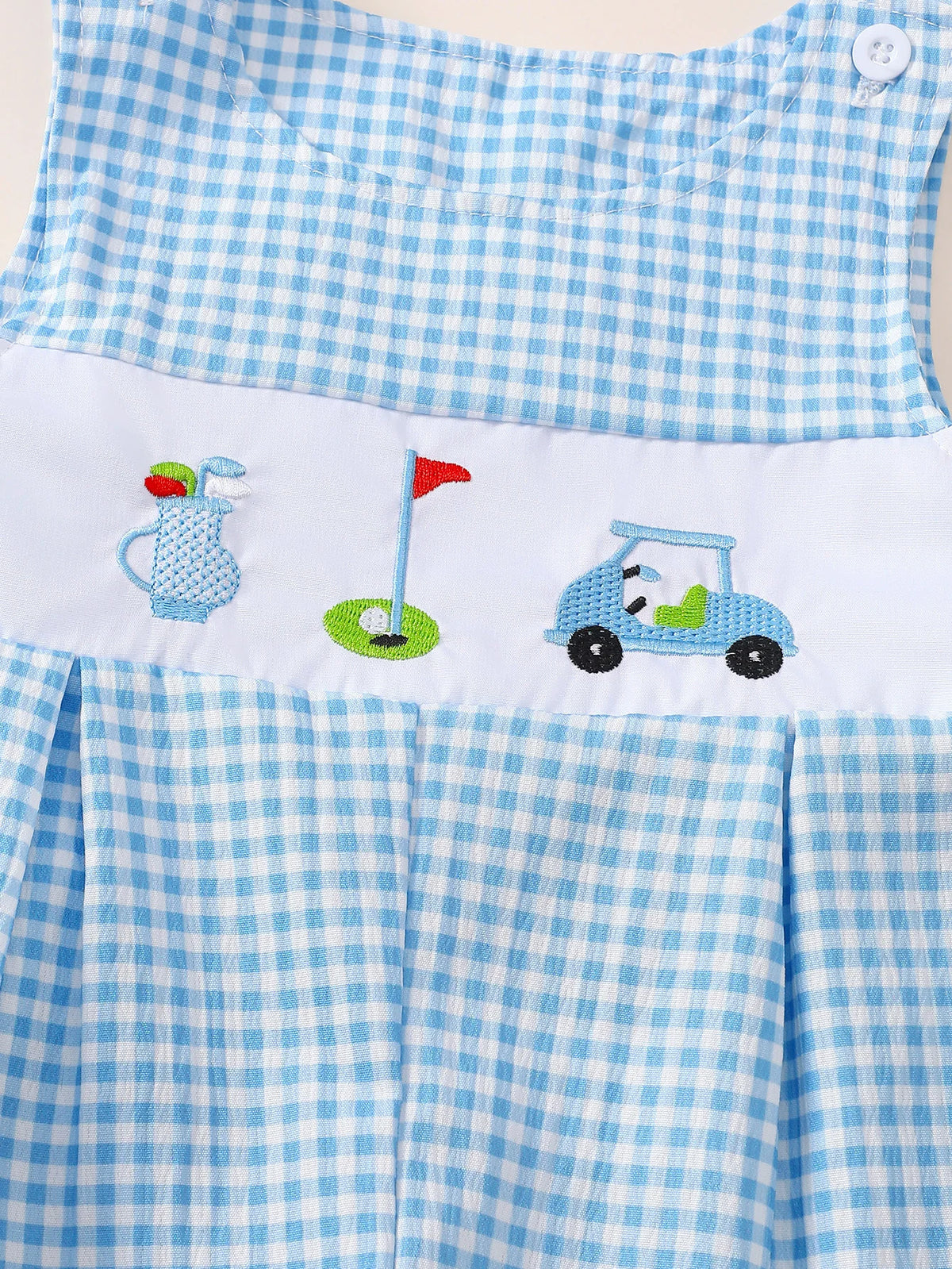 Blue and white gingham baby romper with embroidered golf bag, flag, and cart on white panel. Sleeveless button closure design.