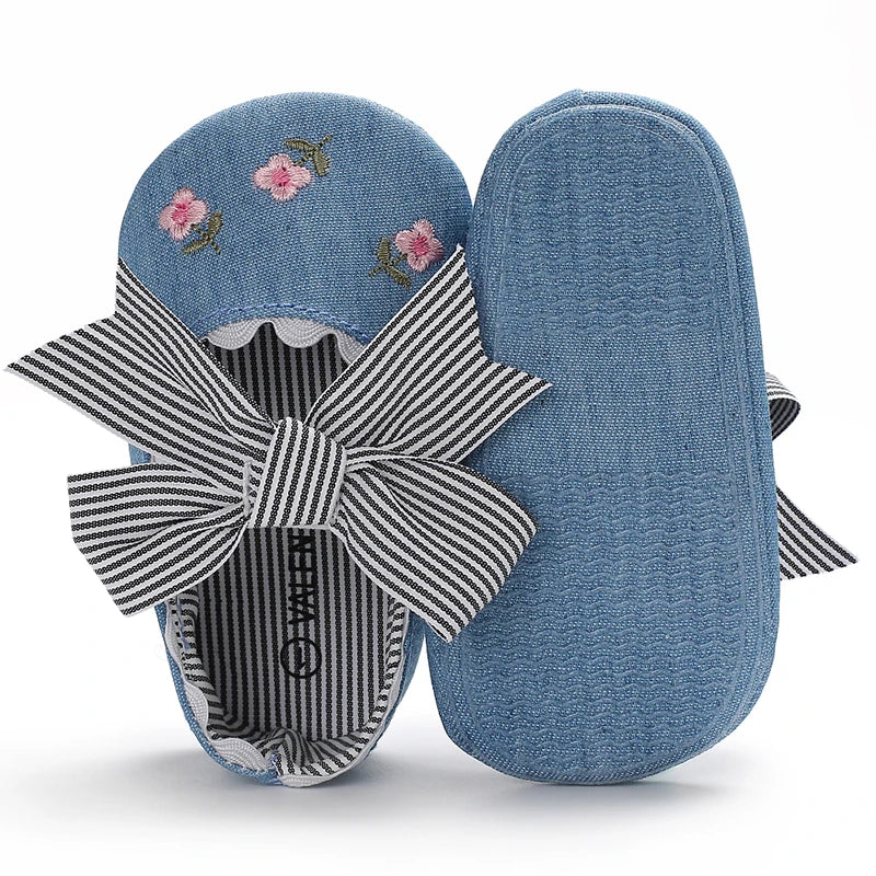 Girls' Mary Jane Soft Cloth Sole Flats Bow Detail in denim with floral embroidery, perfect for little girls aged newborn to 18 months.
