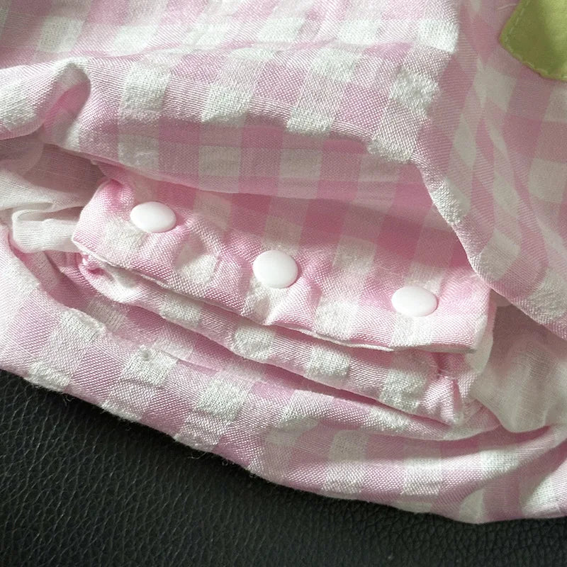 Close-up of the button details on the "Watermelon-licious" Party Romper Dress, highlighting the quality craftsmanship and playful design.