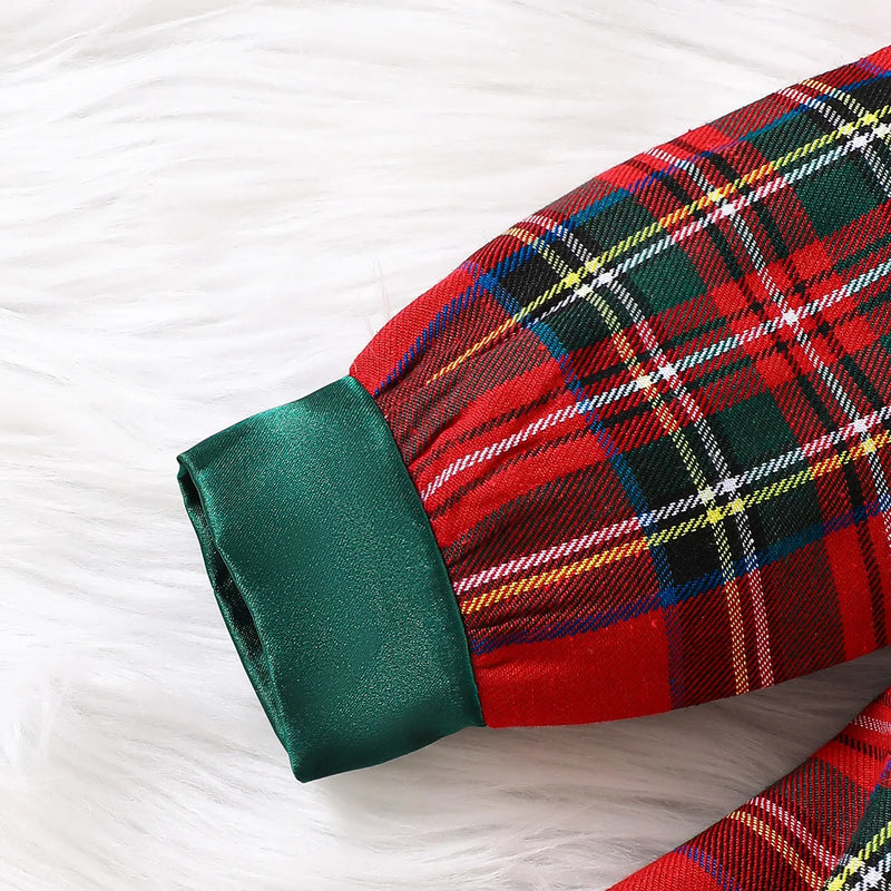 Close-up of the cuff sleeve on the Louisa Girls Red Plaid Bow Dress, featuring a shiny green satin finish that complements the vibrant plaid pattern.
