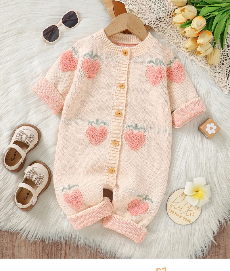 Pretty in Princess Peach Knitted Romper displayed on a soft background, showcasing cute crocheted peach details and cozy round neckline.