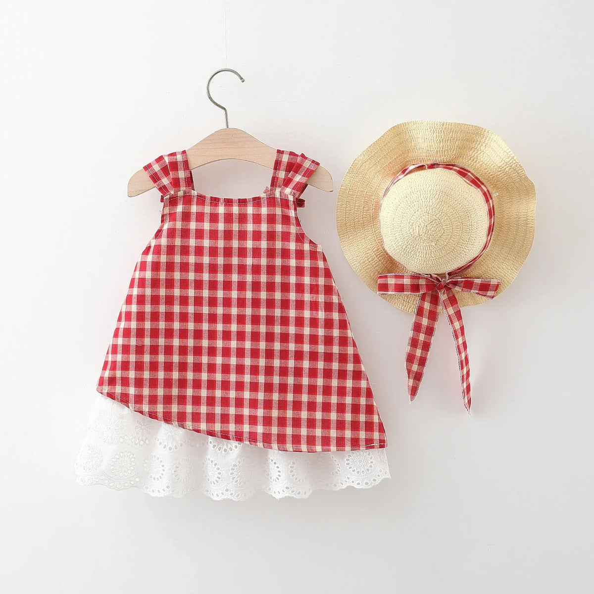 Red and white gingham party dress for toddlers with white lace trim and matching straw hat