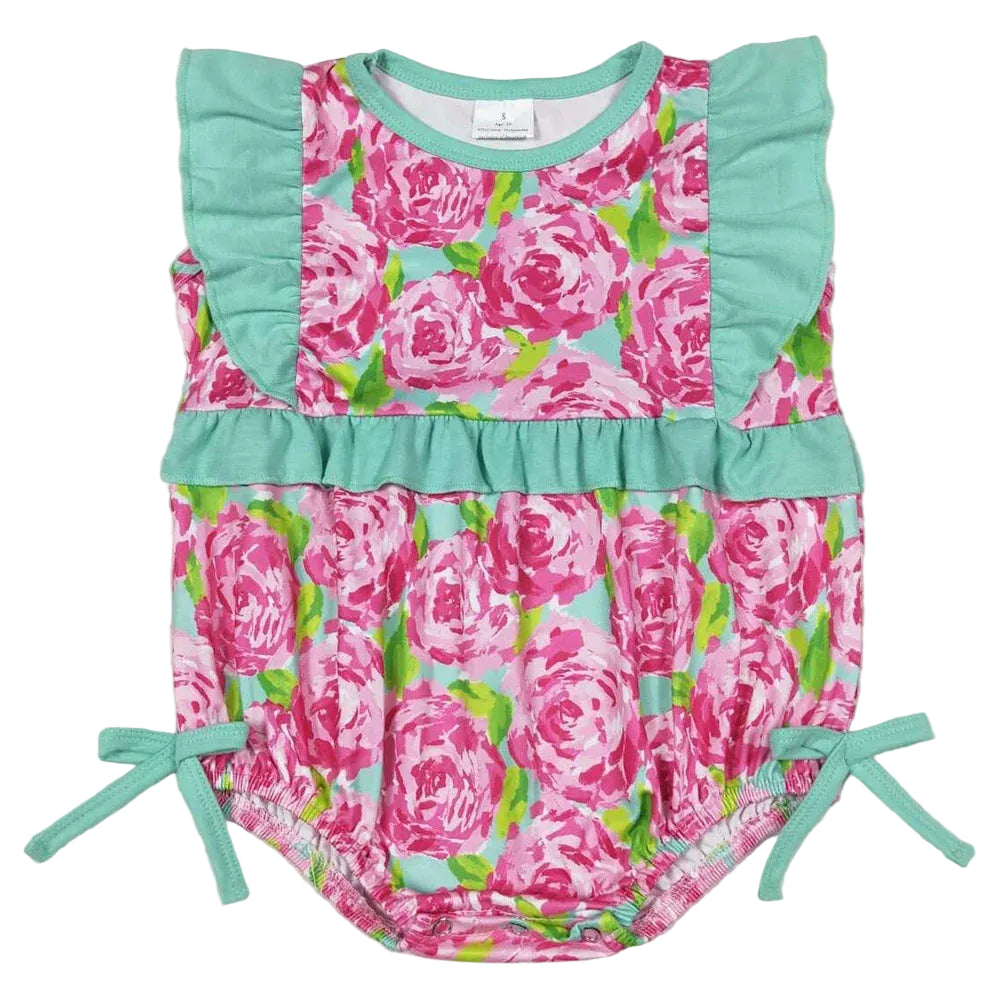 Floral baby romper with green accents on a light gray background