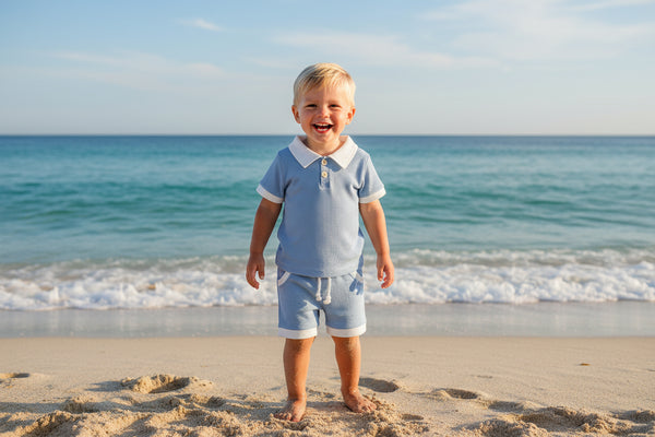 Children's blue checkered outfit with white collar and shorts on a white background