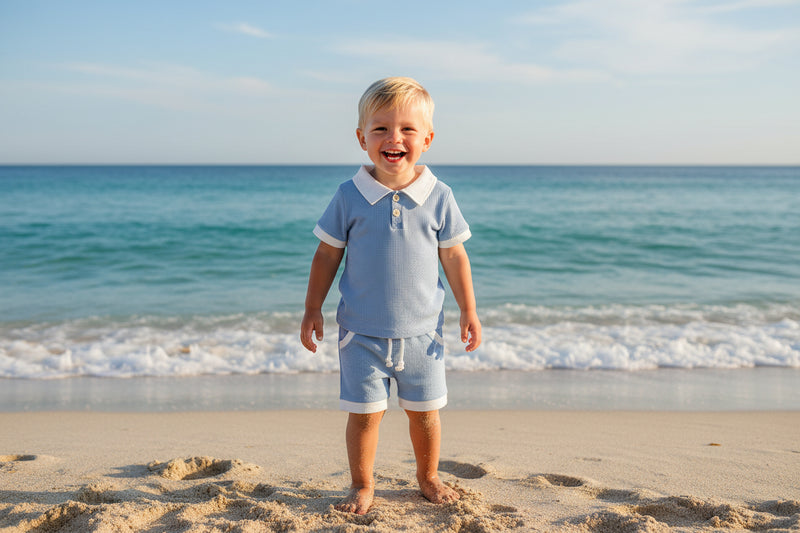 Children's blue checkered outfit with white collar and shorts on a white background