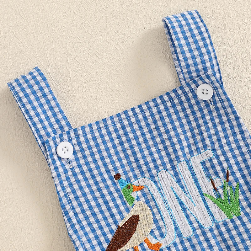 Close-up of the shoulder straps on a duck themed birthday romper with button detail, showcasing its stylish design.