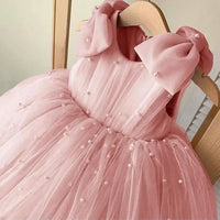 Daria Tulle and Pearls Party Dress in pink with pearl embellishments and shoulder bows for girls 6m–12y.