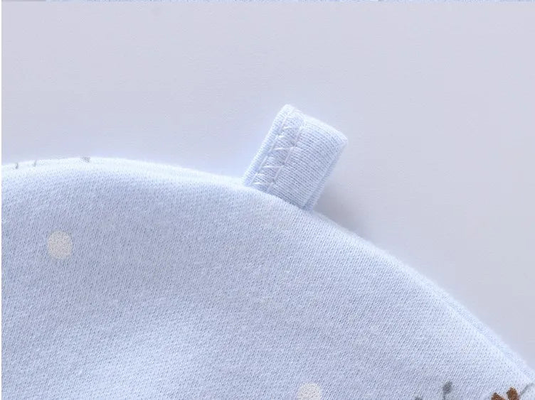 Soft blue cotton fabric with a sewn loop tag, from a giraffe-themed 7-piece newborn layette set.