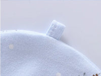 Soft blue cotton fabric with a sewn loop tag, from a giraffe-themed 7-piece newborn layette set.