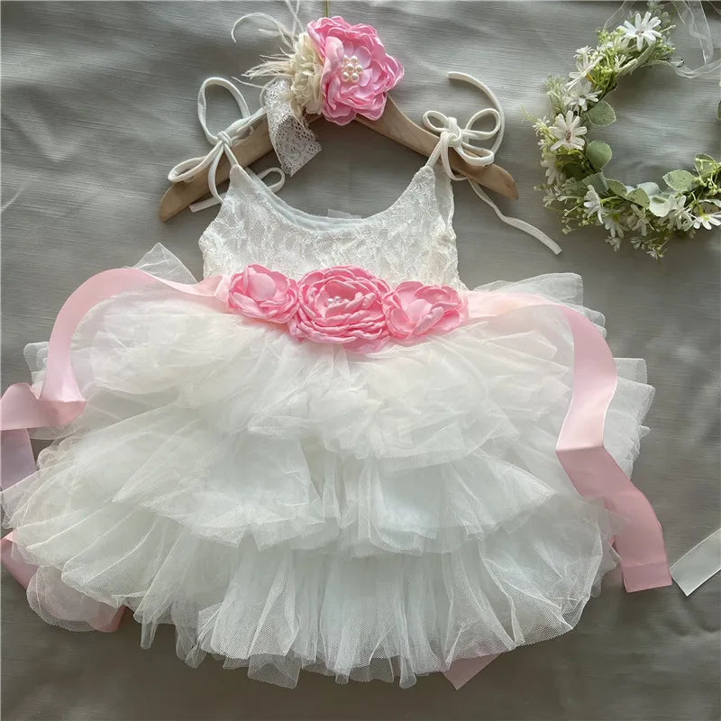 Cecilia vintage tiered tulle dress for special occasions with lace bodice, pink floral belt, and matching headband.
