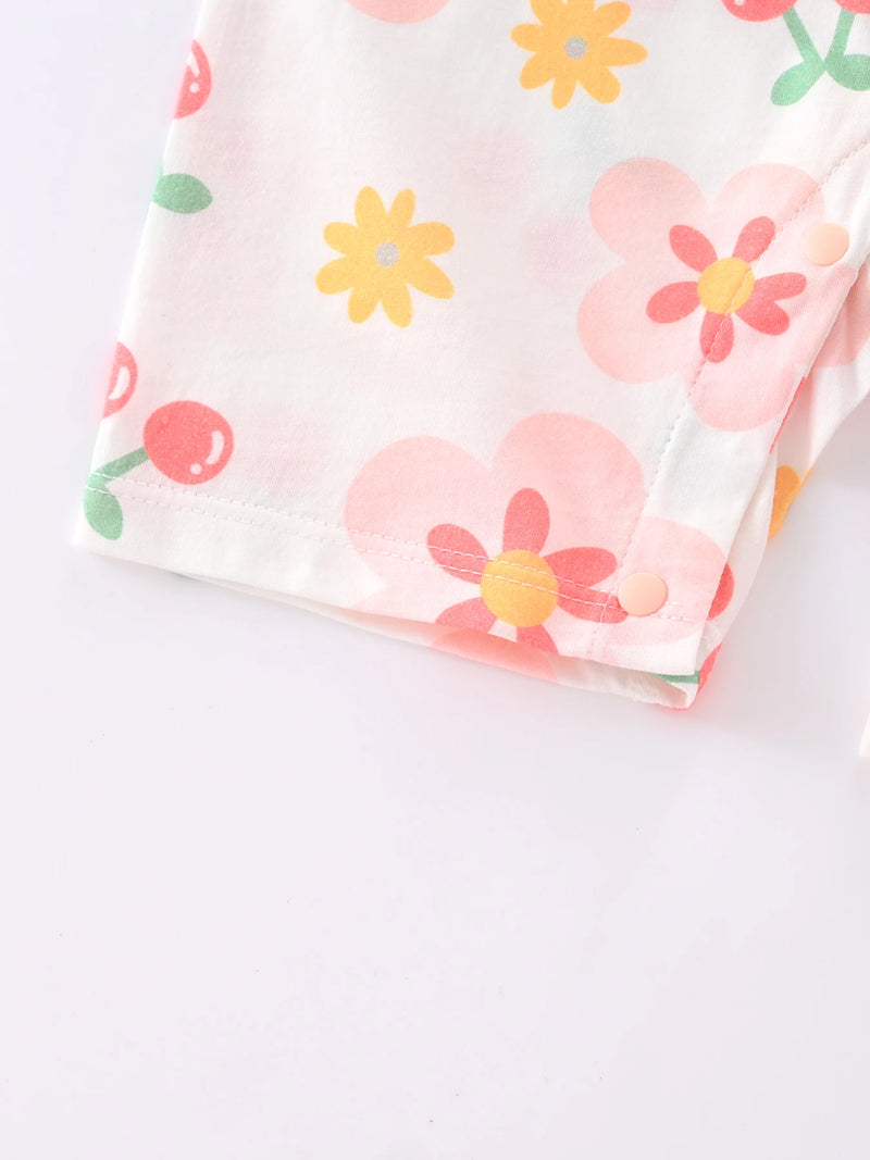 Detail shot of the leg opening of the Floral Baby! Romper Outfit showing the playful floral pattern. The ultimate baby romper outfit for 1 month to 1 year old.