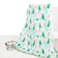 Two-layer bamboo cotton baby swaddle blanket with green leaves and pink floral pattern.