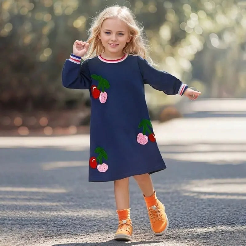 A Fruit a Day Adorable Preppy Navy A-Line Dress worn by a young girl, featuring vibrant fruit appliques, perfect for trendy little fashionistas.