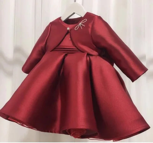 Patience Marie burgundy satin girls' formal dress with long sleeves, beaded bow, knee-length, princess-style.
