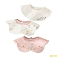 3-Piece embroidered baby bibs set in pink and white featuring bear, floral, and rabbit designs with snap closures.