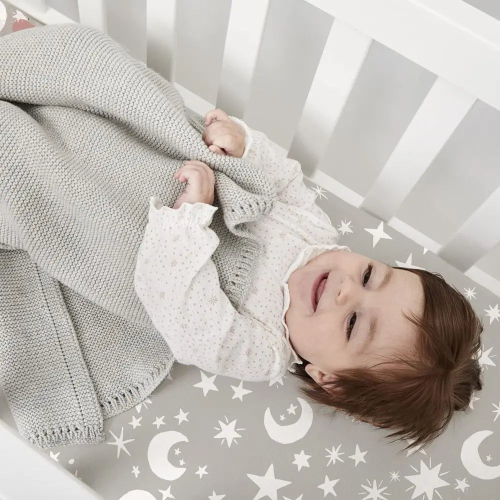 4-pack extra soft microfiber crib sheets set for babies; gray starry moon design on crib with smiling baby.