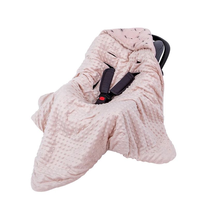 Adorable Ultra-Soft Baby Swaddle Blanket in a soft pink hue, elegantly draped over a car seat, perfect for keeping infants warm during travel.