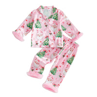 Pink girls Christmas pajama set with Santa, trees, and bow print. 2-piece satin loungewear with fuzzy cuffs for holiday wear.