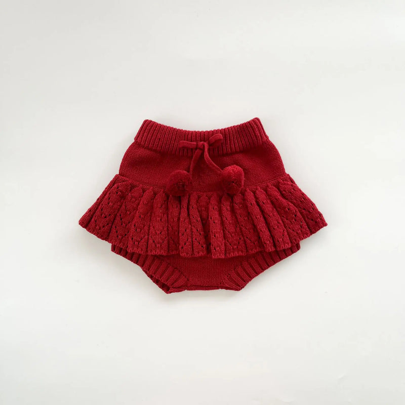 Charming red toddler skorts designed to match the Popcorn Knit Pullover, creating a delightful outfit for young children.