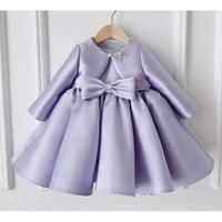 Lilac satin girls' formal dress with long sleeves, waist bow, knee-length princess silhouette.