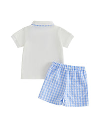 Back view of a boys' white polo shirt with blue check trim and blue gingham shorts.
