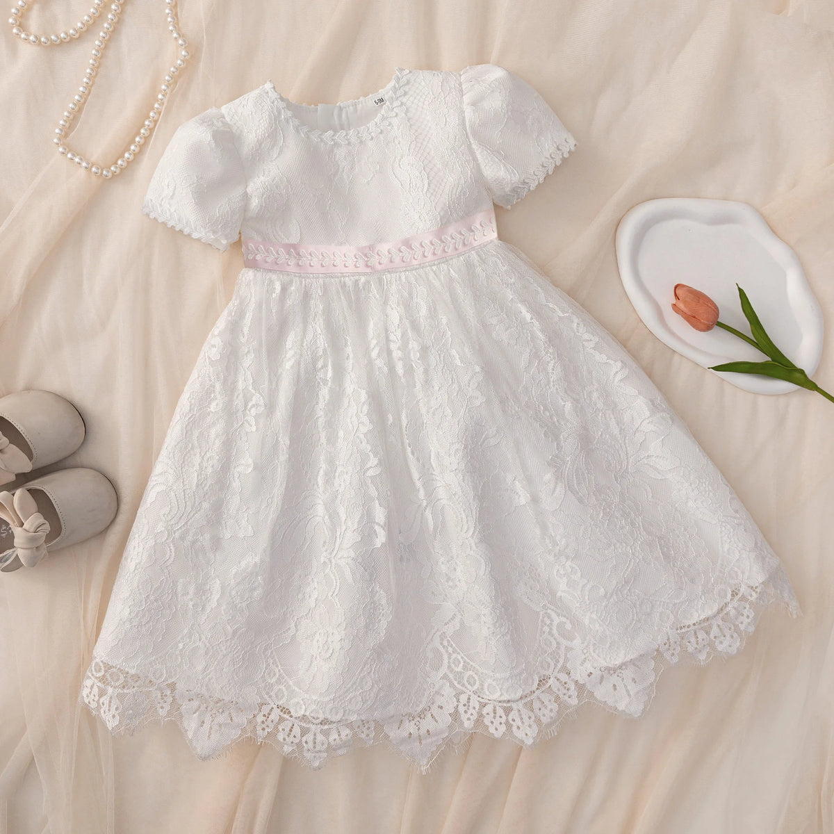 Tabitha Baptism Flower Girl Dress: white lace, pink waist sash, short sleeves, knee-length, back zipper.