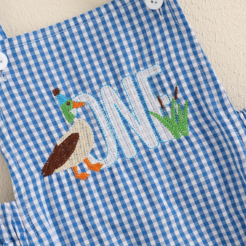 Close-up of the embroidered duck and 'ONE' on a duck themed birthday romper, making it a cute outfit for first birthdays.