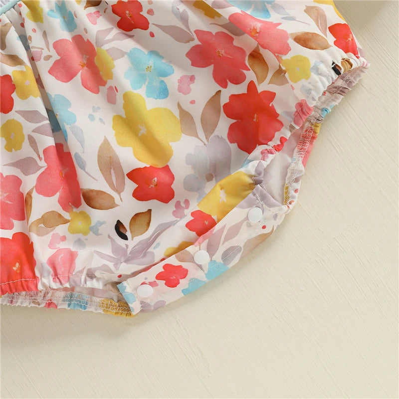 Close-up of the floral pattern on the "Fall Fabulous" Pumpkin Embroidered Bubble romper, showcasing vibrant red, blue, and yellow flowers, perfect for autumn-themed outfits for babies.