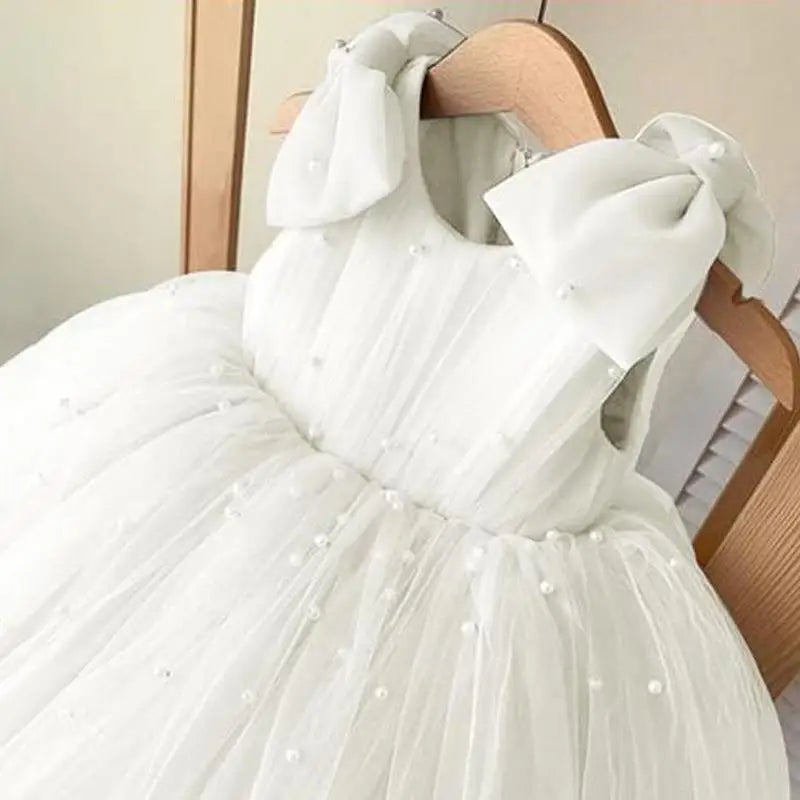 Daria Tulle and Faux Pearls Party Dress in white with shoulder bows and pearl accents for girls (6m-12y).