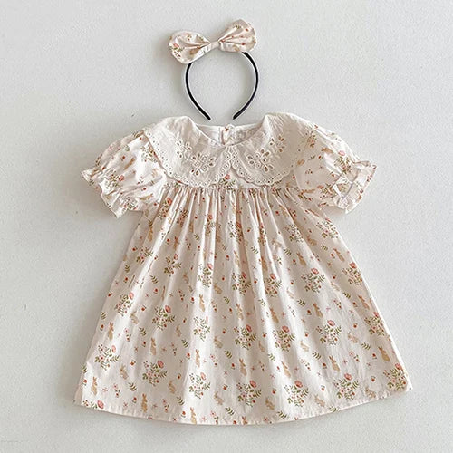 Vintage Outfits for babies featuring a floral dress with puffed sleeves and a matching headband.