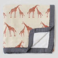 Two-layer bamboo-cotton baby blanket with giraffe print, cream front and gray border.