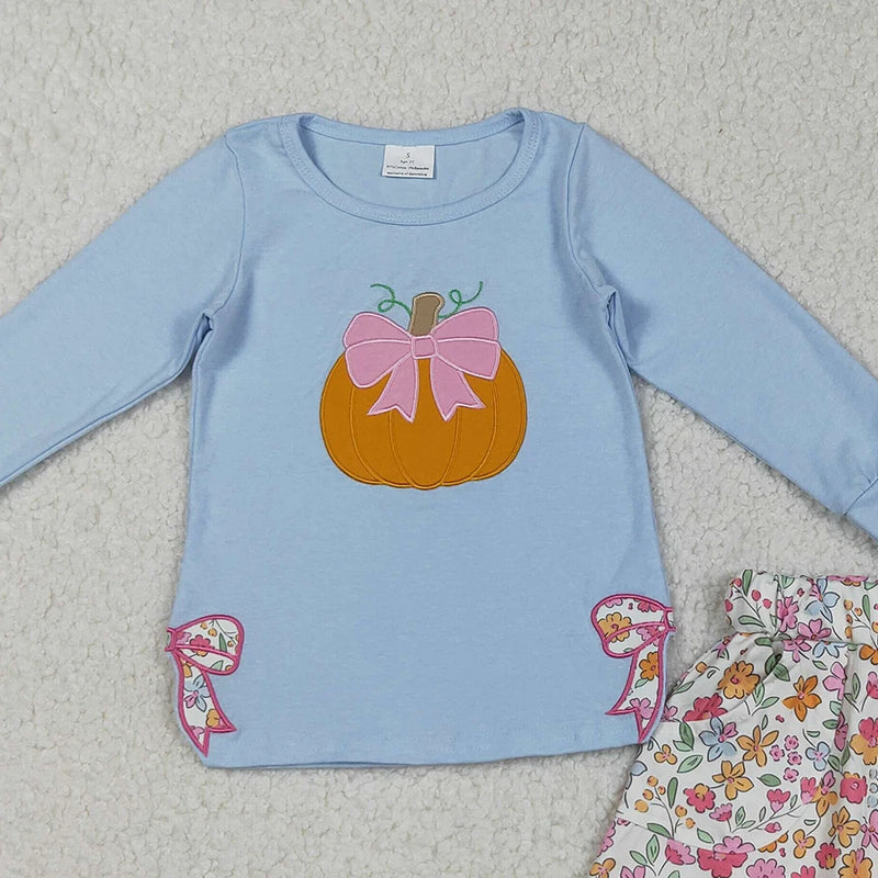 Detailed view of the embroidered pumpkin design on the Pumpkin Fleurs Baby Girls' Embroidered Skort Outfit, featuring sweet blue bows on the top.