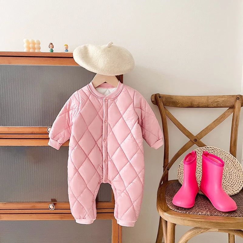 Pretty pink baby quilted romper displayed with a cute beret and pink boots, ideal for stylish winter outings.