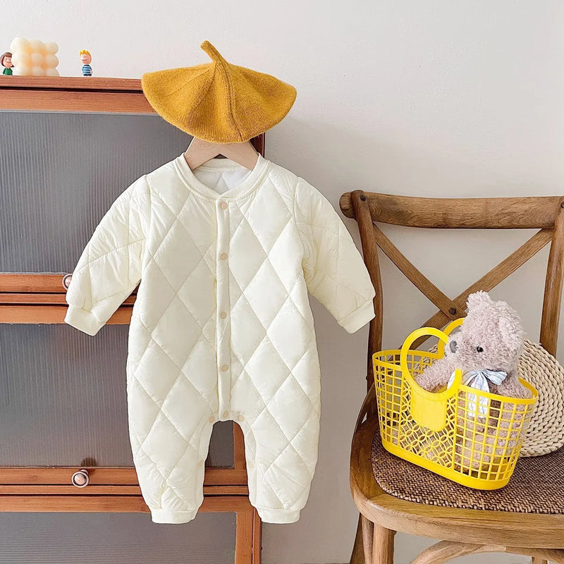 Sunny yellow baby quilted romper on display with fun accessories, perfect for chilly days and baby adventures.